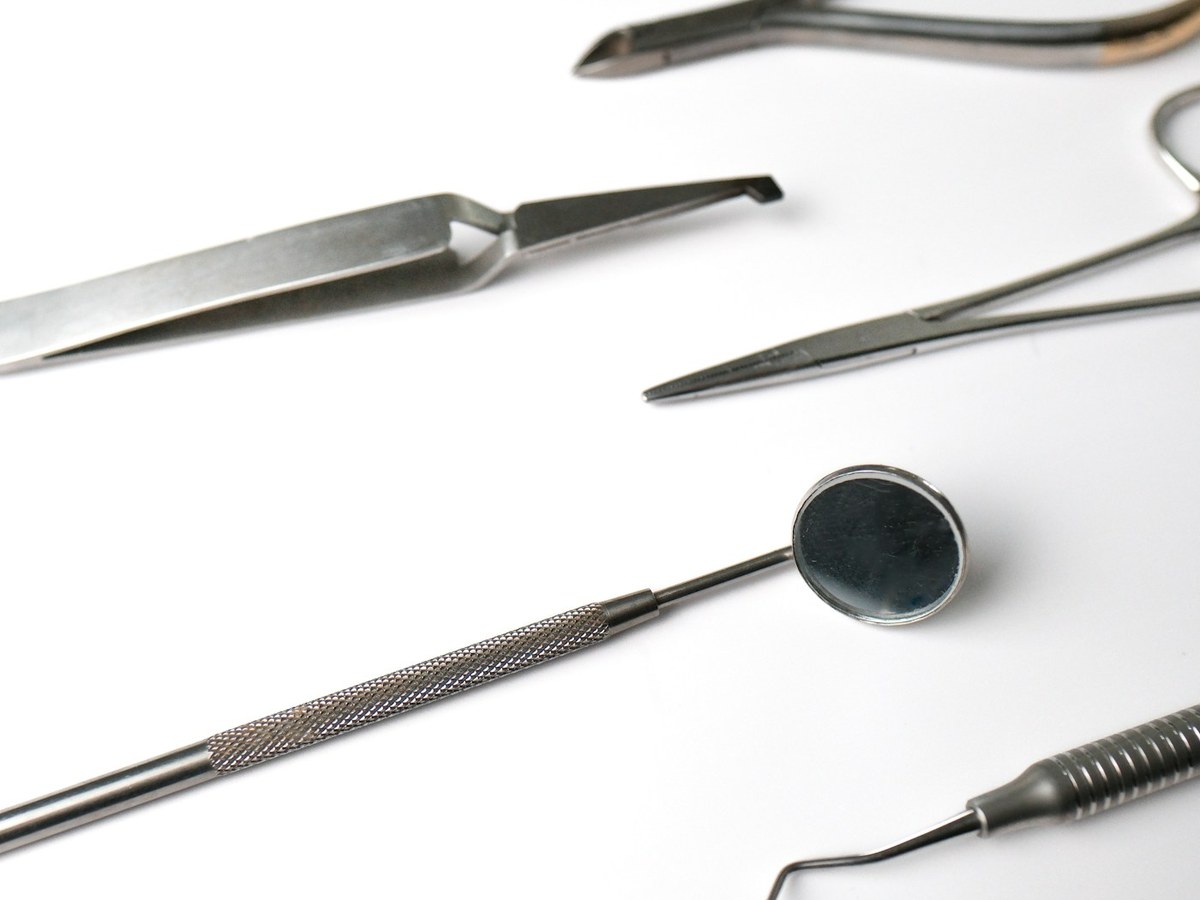 Dental instruments arranged on a white surface
