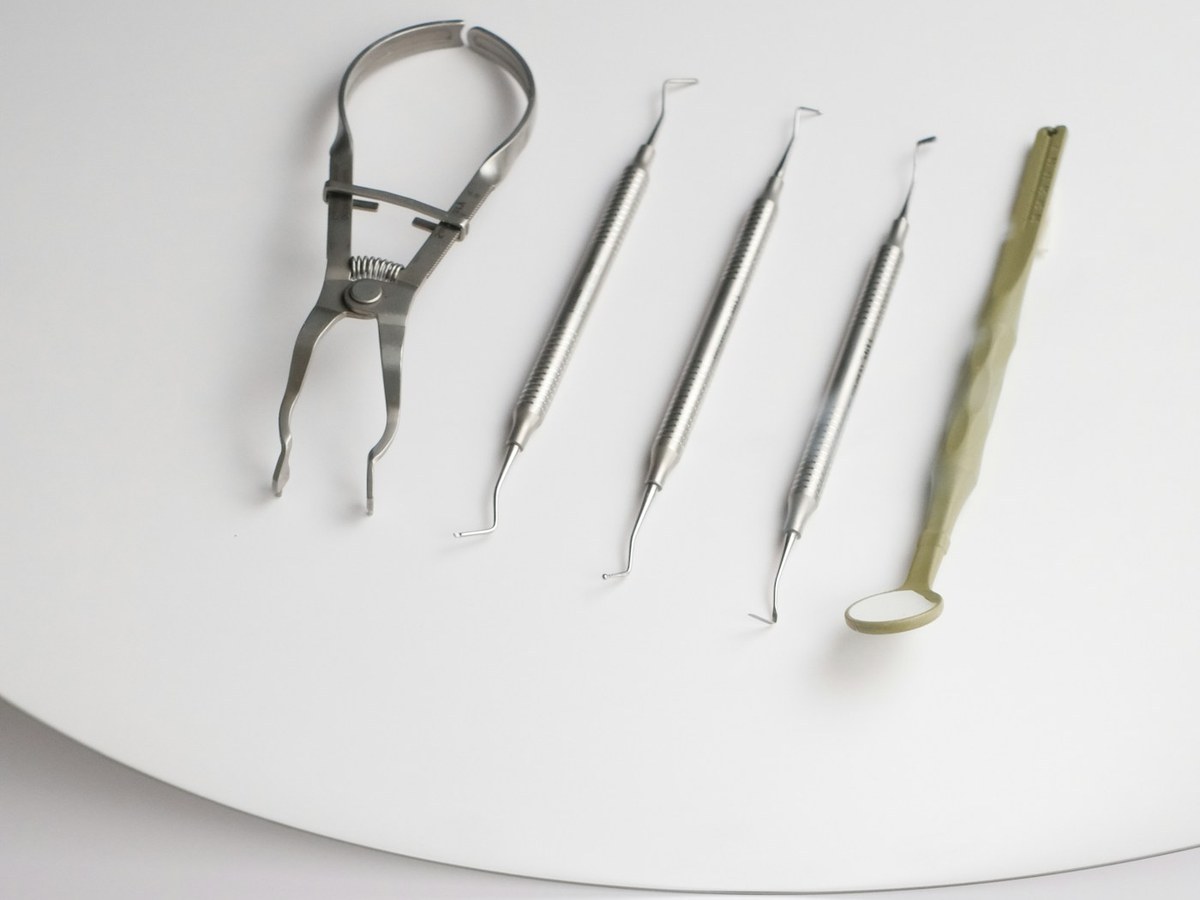 Clean dental instruments arranged on a white surface