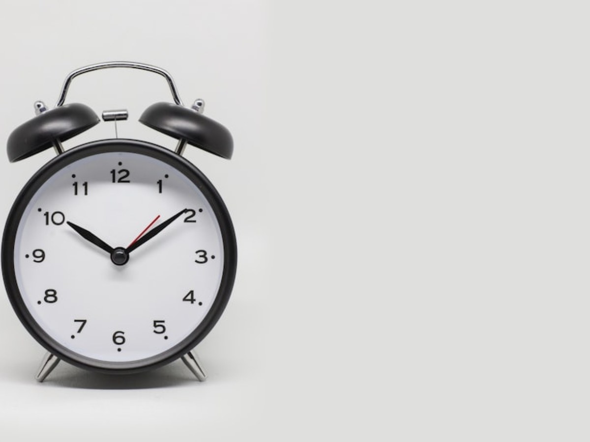 Alarm clock standing against a plain grey background
